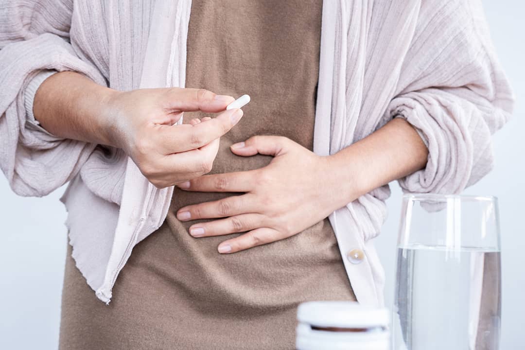 Person taking a probiotic pill